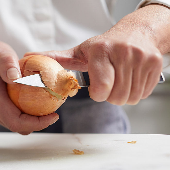 Knife cutting onion